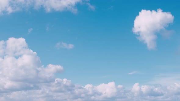 Time lapse of clouds and bright blue sky. Fast timelapse white and dark cloudsing towards the camera