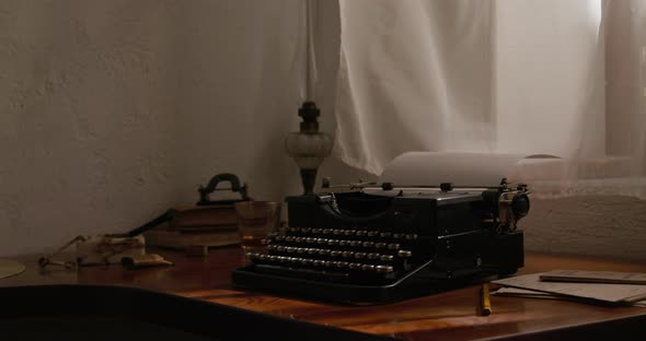Old typewriter in front of an open window