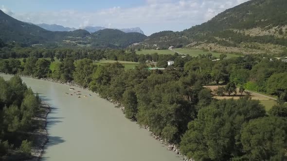 total shot of river in France going away from canoes and floating boats