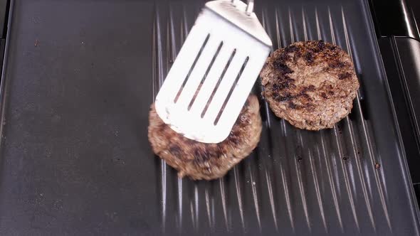 Flipping Beef Burger Patties