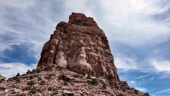 Looking up and rotating around desert cliff tower in the Utah desert