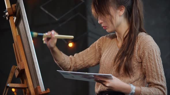 Inspiring Woman Is Drawing Her Painting Indoor