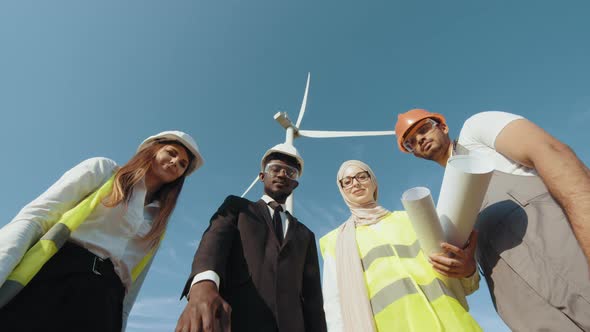 Men and Women in Safety Helmets Having Successful Meeting Outdoors