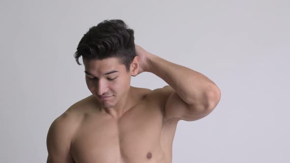Young Handsome Muscular Shirtless Man Brushing Hair Back
