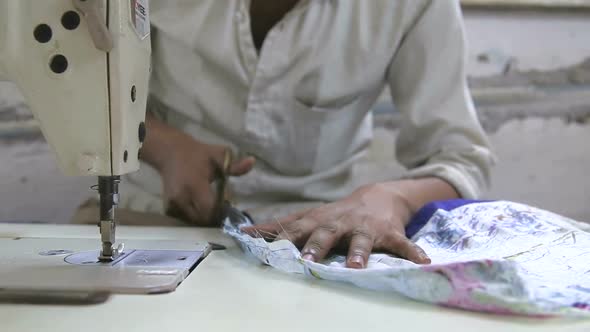 Boy sewing clothes on a machine in Mumbai.