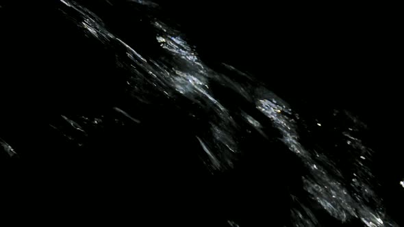 Amazing Jet of Water Falls and Splashes Against a Backlit Black Background in Slow Motion. Beautiful