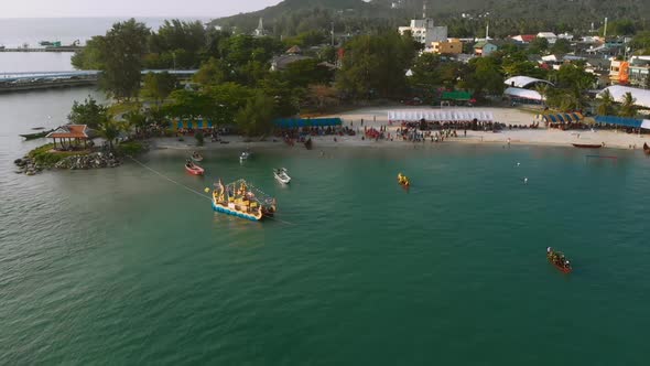 Traditional Thai Boat rowing competitions in bay of tropical island during sunset