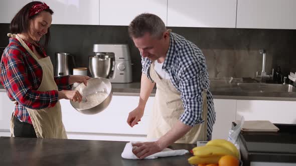 Cheerful Couple Cooking at Kitchen Together