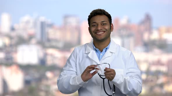 Young Indian Doctor Putting on Stethoscope