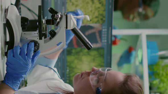 Vertical Video Scientist Doctor Analyzing Botanical Plants Under Microscope