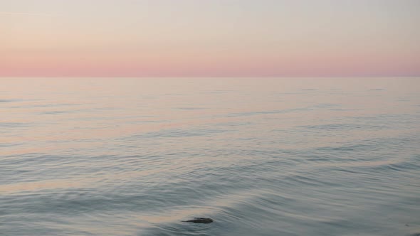 Baltic sea at sunset,small waves hitting stones