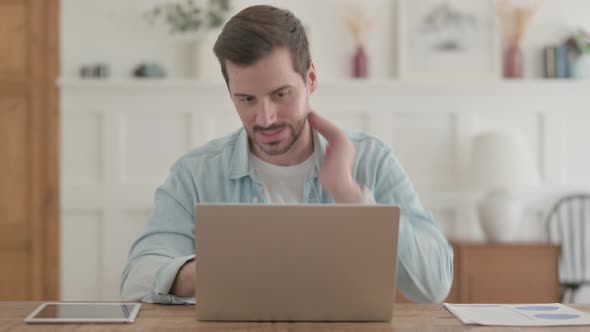 Distressed Young Man Feeling Frustrated While Working on Laptop