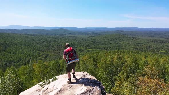 A Tourist Photographer Climbed to the Top of the Mountain to Take a Photo