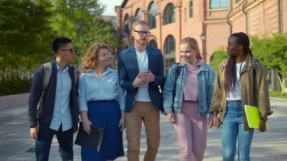 Diverse Students Walking Together and Embracing Having Break After Classes 