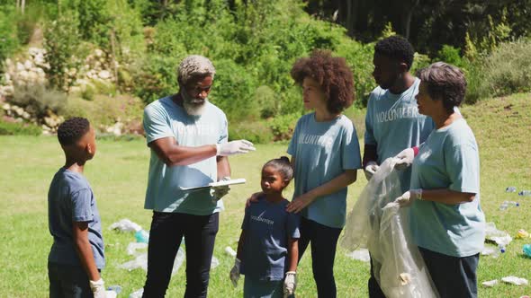 Happy family cleaning a garden together