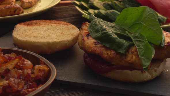 Female Hands Making a Homemade Grilled Burger with Chicken Fillet and Spinach