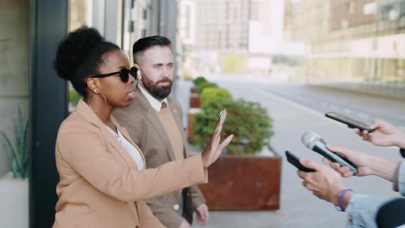 Black Woman Walking with Bodyguard and Refusing to Speak to Media