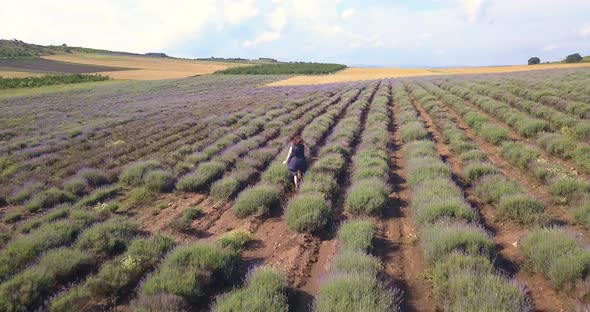 Woman with Hat Running Joyfully Through a Lavender Field