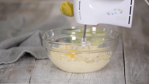 Making buttercream frosting for decorating a vanilla cake.