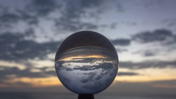 Time Lapse Clouds Above The Sea In Crystal Ball At Twilight.