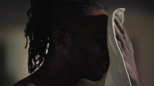 Closeup Perspiring Face of African American Sportsman Wiping Sweat Smiling Looking at Camera