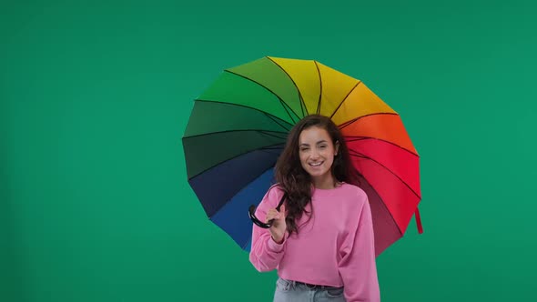 Happy Young Female with Stylish Multicolored Umbrella on Green Screen, Chroma Key.