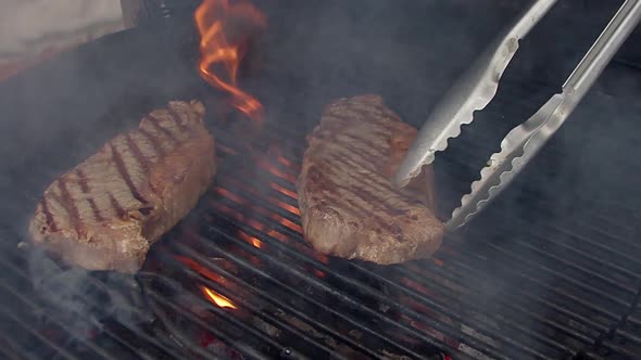 006Steak on grill. Grilling on fire meat.