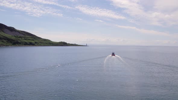 A Small Passenger Ferry Heading Towards an Island in the Summer