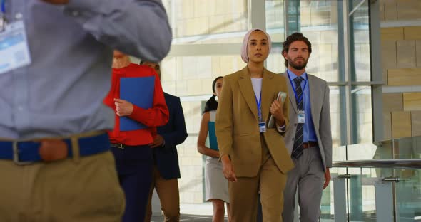 Business people walking in the corridor at office 4k