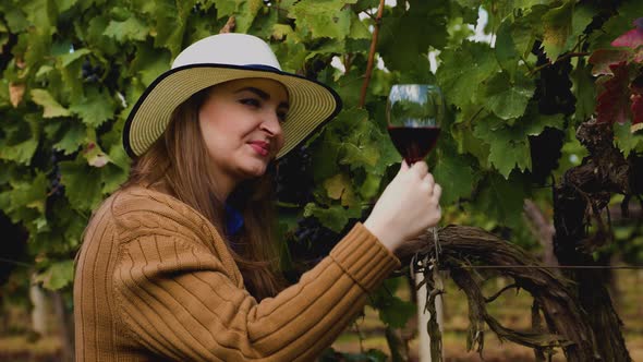 Profile View of a Happy Woman Winemaker Tasting Red Wine