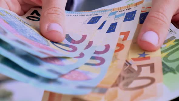 Slow Motion Business Woman Displaying a Spread of Cash Euros