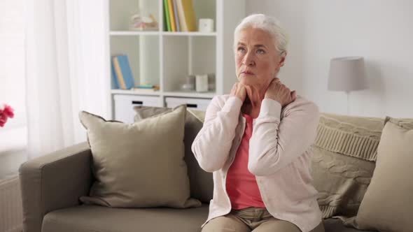 Senior Woman Suffering From Neck Pain at Home