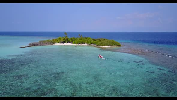 Aerial flying over tourism of tranquil lagoon beach voyage by blue ocean and white sand background o