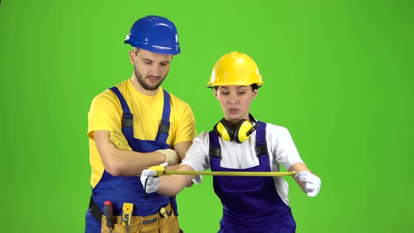 Engineer Girl Measures a Roulette Building, Green Screen