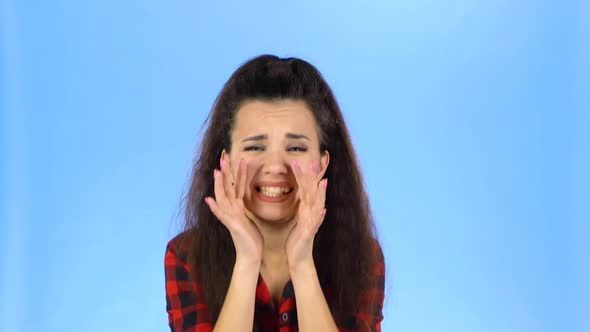 Pretty Lady Is Shouting with Her Hands Near Her Mouth