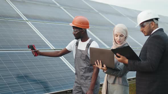 African American Technician Showing Temperature of Solar Panels on Thermal