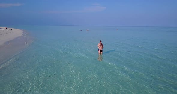 Happy lady and man on honeymoon vacation enjoy life on beach on paradise white sand background 