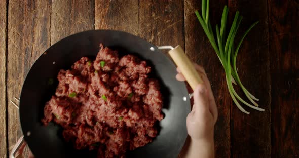Men's Hands Put on the Table a Pan with Minced Meat. 