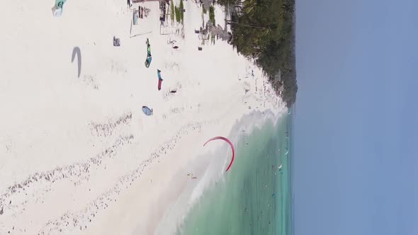 Vertical Video Kitesurfing Near the Shore of Zanzibar Tanzania Aerial View