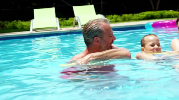 Family enjoying in swimming pool