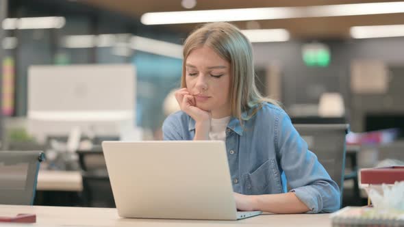 Young Woman Falling Asleep While Using Laptop in Office Nap