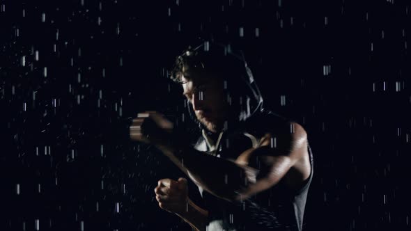 Athletic Man Boxing In The Rain