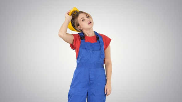 End of working day Construction worker woman taking hardhat