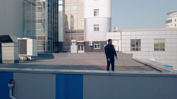 Upper View Young Man Stands on Modern Factory Roof