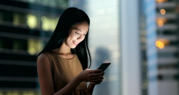 Woman use of smart phone in the evening 