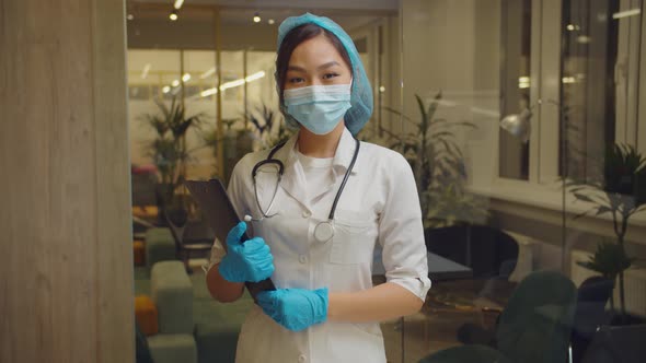 Positive Asian Female Doctor Smiling at Hospital