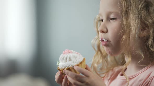 Close-Up of Pretty Little Girl Biting Cake and Enjoying Perfect Taste of Dessert