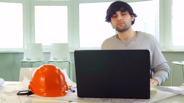 Architect Closes the Laptop at the Office