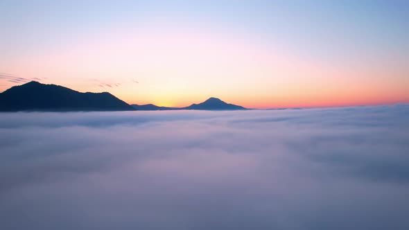 4K Aerial video Beautiful sunrise above dense clouds and fog in the morning