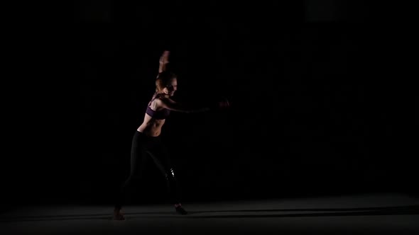 Unusual Contemporary Moves Making By Girl in the Shadow on Black Background, Slow Motion